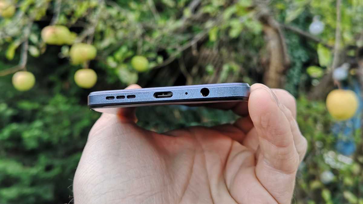 A close up of the Motorola Moto G84 5G's bottom edge, detailing the external speaker, USB-C port, and 3.5mm headphone jack