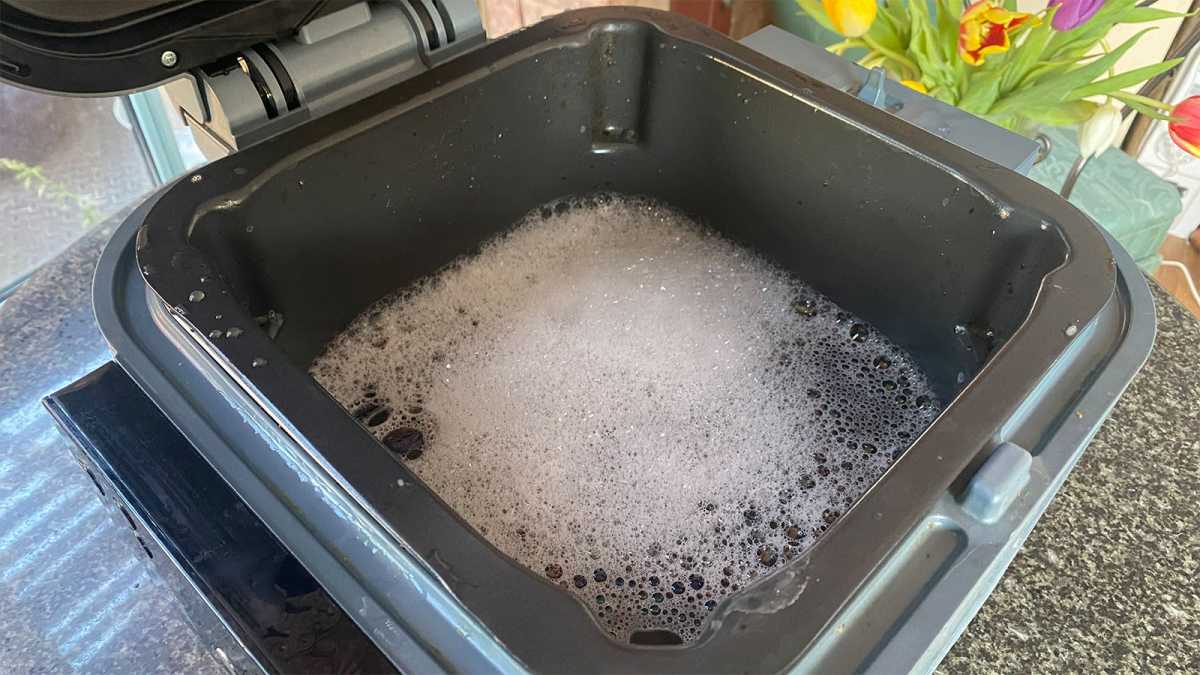 Air fryer filled with soapy water