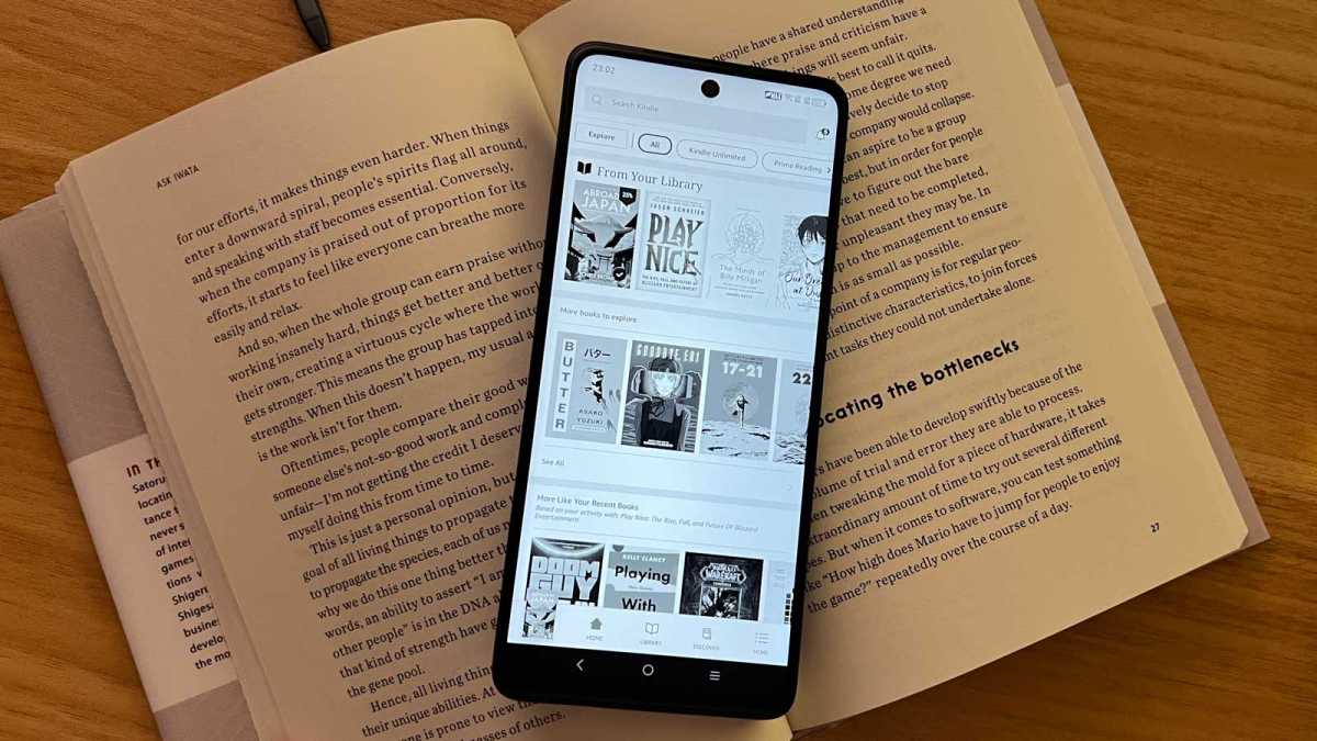 The TCL 50 Pro NXTPAPER sitting on a book.